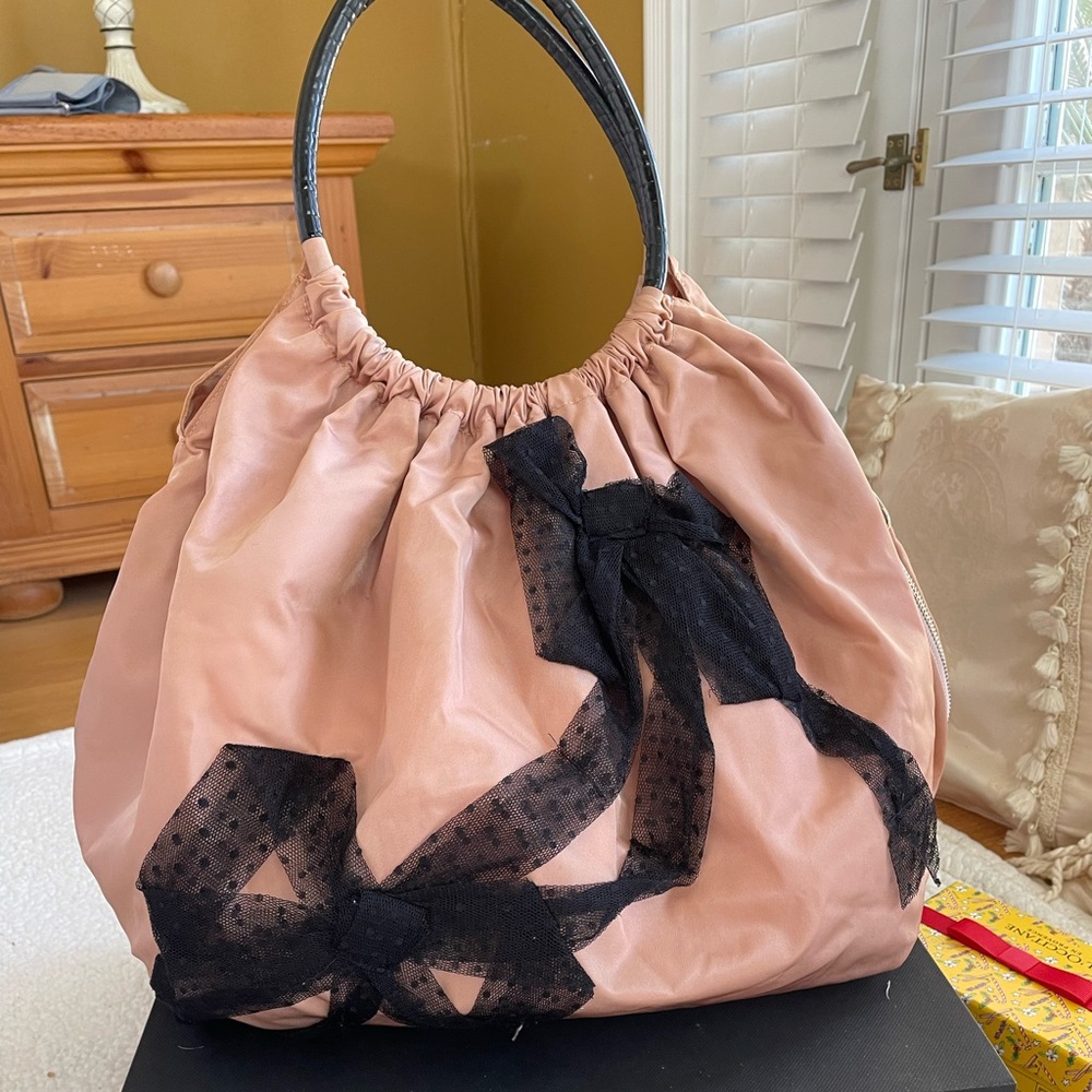 Red Valentino bag the color is light pink .